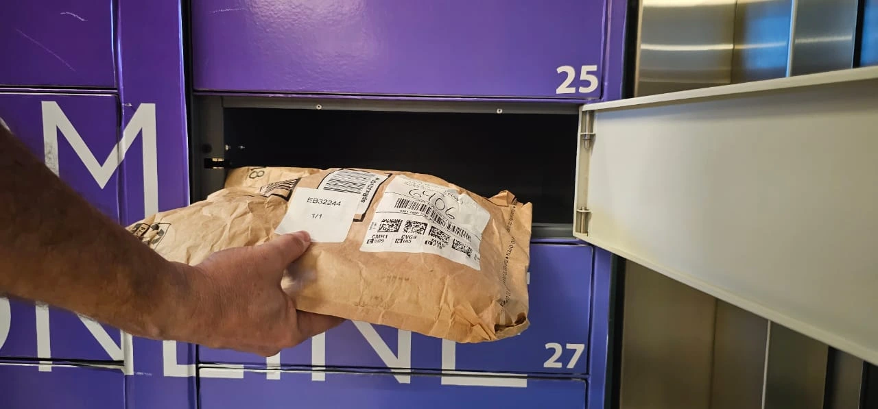 Package pickup at a purple Boxit locker