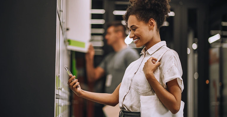 Woman using her phone beside smart lockers